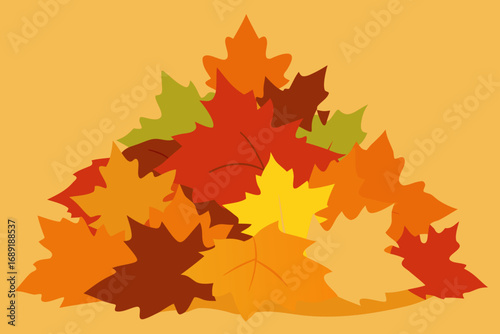 Pile of colorful autumn maple leaves on a warm orange background