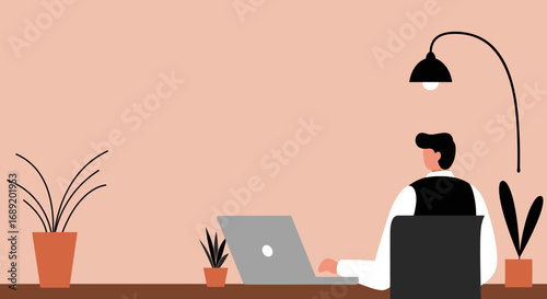 Man works diligently on his laptop at a modern desk setup with plants, ideal for remote work, business, and productive lifestyle concepts.