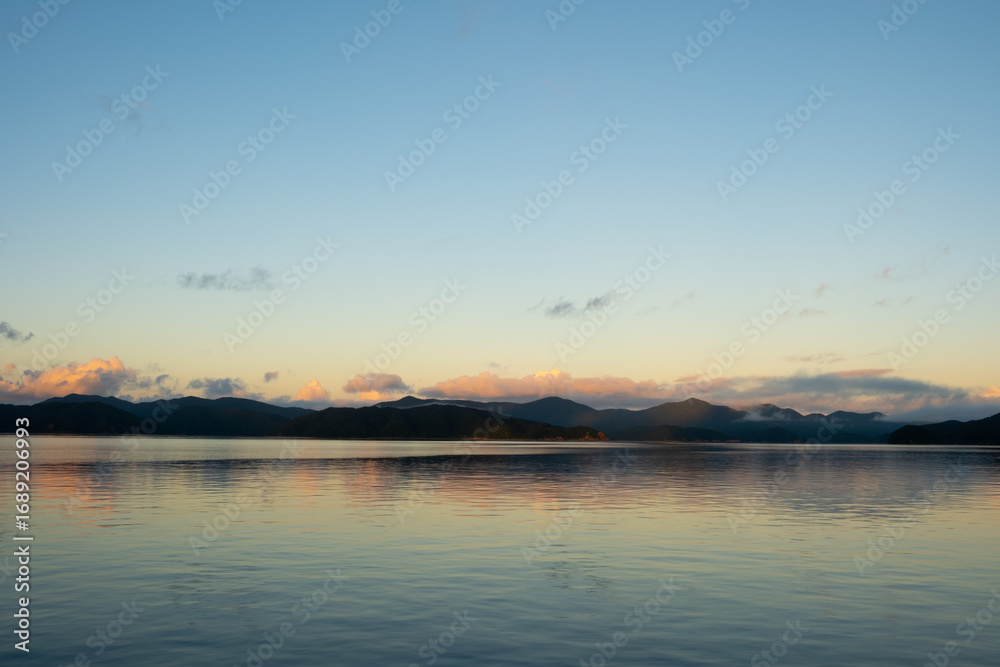 Fototapeta premium Sunrise Over Mountains and Ocean in Amami Oshima