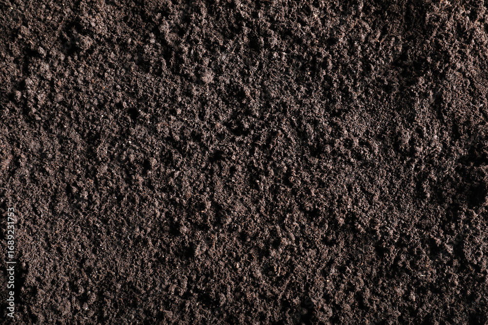 Fototapeta premium Fresh soil as background, top view. Organic matter