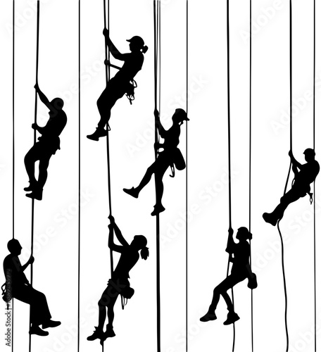 Silhouettes of Climbers Ascending Ropes