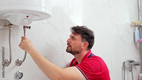 Plumber checking water heater in bathroom