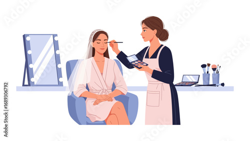Professional makeup artist applying cosmetics to a client in a salon setting with mirror and laptop