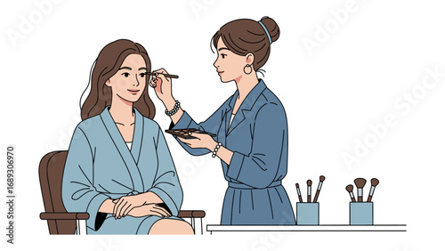 Professional makeup artist applying eye makeup to a young woman sitting in a chair wearing a robe