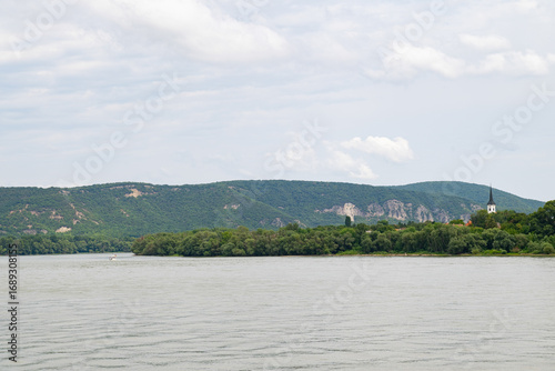 Wallpaper Mural The wide waters of the Danube River and green hills. A peaceful and tranquil river view for nature lovers. Torontodigital.ca