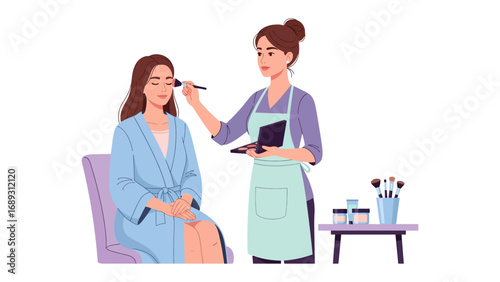 Professional makeup artist applies blush to a smiling woman wearing a blue robe in a bright clean studio setting