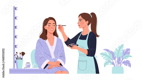 Professional makeup artist applying cosmetics to a smiling woman in a light blue robe