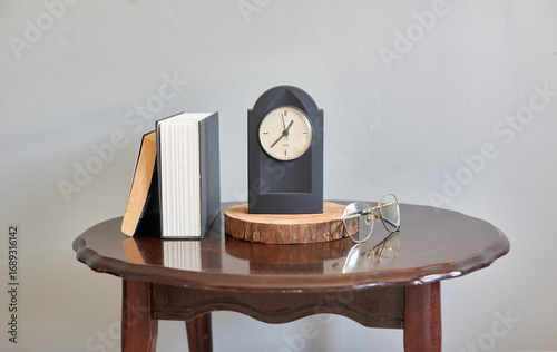 Classic Still Life with a Modern Clock, a Stack of Books, and Re
