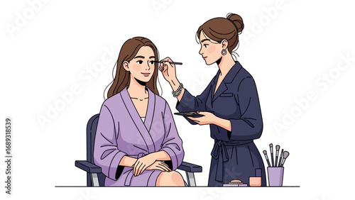 Professional makeup artist applying cosmetics to a seated woman in a bathrobe for a beauty session