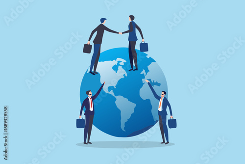 Businessmen shaking hands on top of a globe representing global business and international cooperation