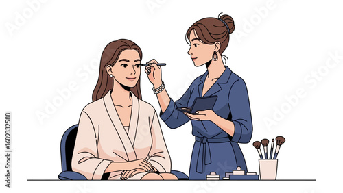 Professional makeup artist applying eye makeup to a seated woman in a robe with brushes nearby