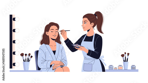 Professional makeup artist applying eye shadow to a client in a beauty salon with makeup brushes and products
