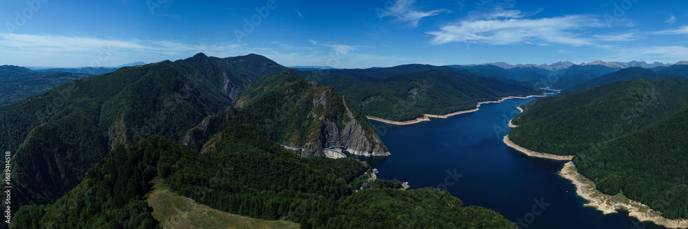 Fototapeta premium Aerial drone panorama view of Vidraru dam and lake in Fagaras mountains, Romania.
