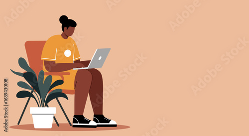 Young woman working remotely on her laptop from a comfortable chair at home, embodying modern freelance lifestyle and productivity.