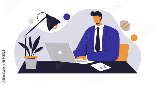 Professional man in a suit focused on working with his laptop at a modern desk. Ideal for business, remote work, technology, or corporate productivity concepts.