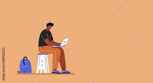 Young man working on a laptop while sitting on a stool with a backpack nearby, representing remote work, online learning, and digital lifestyle.