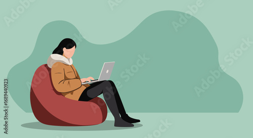 Young person comfortably working on a laptop while sitting on a bean bag, depicting modern remote work or relaxed digital lifestyle. Ideal for tech, freelance, and cozy living concepts.
