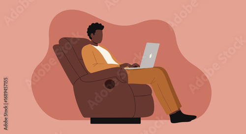 Relaxed African American man working from home on a laptop in a comfortable armchair, illustrating modern remote work and digital lifestyle.