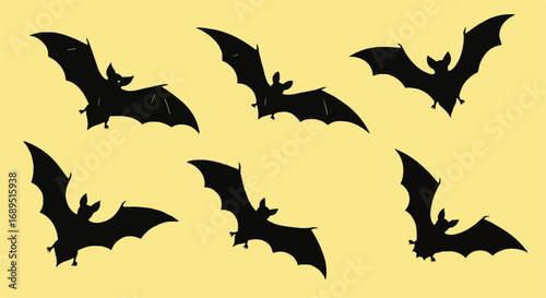 Spooky Flying Bat Silhouettes Collection for Halloween. Dark winged creatures on a warm yellow background, perfect for creepy decorations.