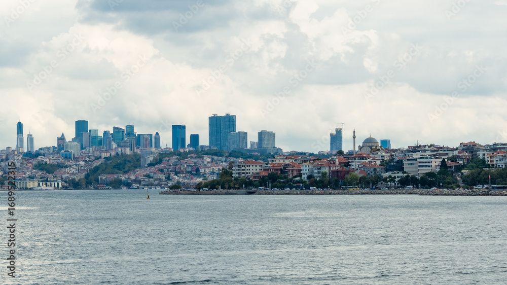 Fototapeta premium Istanbul, Turkey. Scenic view of the Bosphorus Strait with city view in the background. Urban skyline and city life.