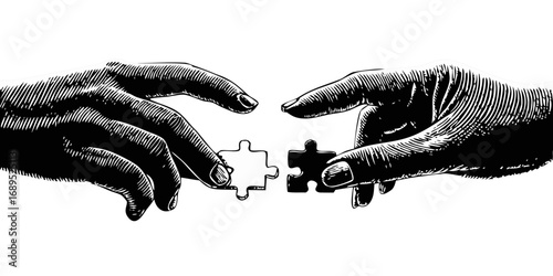 Two hands carefully connecting puzzle pieces in a symbolic representation of collaboration and problem solving