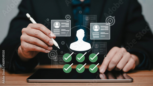 Person reviewing candidate profiles on a tablet with checkmarks and icons recruitment hiring
