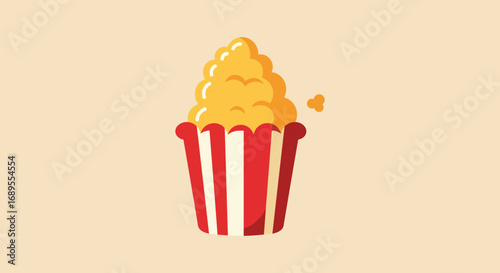 a delicious popcorn overflowing from a red striped bucket
