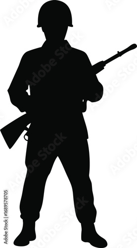 Silhouette of a solider standing guard holding a rifle in a protective stance ready for action silhouette