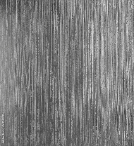 Textured gray surface with vertical lines and subtle variations, creating an abstract background ideal for design projects and artistic applications with copy space