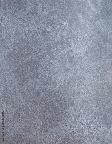 Textured gray surface with a subtle sheen, showcasing intricate patterns and variations, ideal for backgrounds, design projects, and artistic applications with copy space
