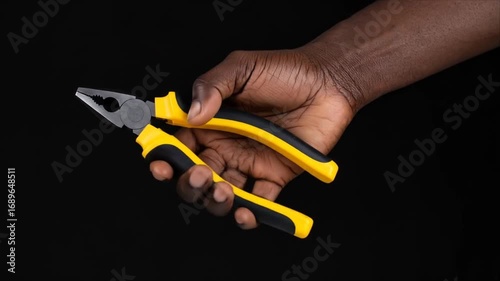 Handheld pliers in dark background