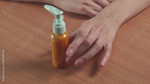 Close-up of woman looking at shampoo in a small compact package at home, recorded with ambient sound.