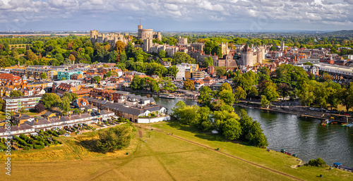 Aerial view of Windsor Castle surrounded by town buildings and lush green landscape