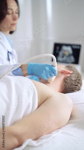 Doctor woman with blue medical gloves performing neck ultrasound exam on male patient
