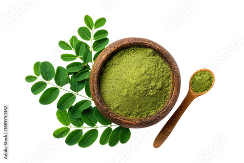 Green Moringa powder in wooden bowl, with leaves
