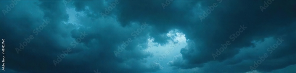 Obraz premium Dark and dramatic stormy skies overhead, heavy clouds filled with rain, ominous and powerful Perfect for weather, nature, and atmospheric imagery , cloudscape, moody, sky texture