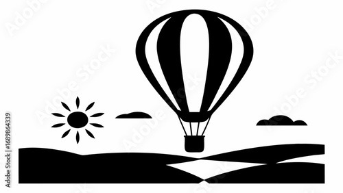 Black and white silhouette of a hot air balloon over a landscape with sun and clouds in the sky view