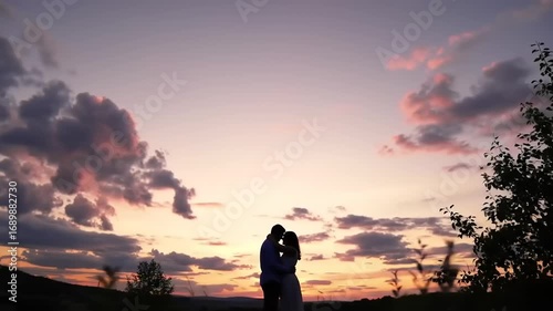 Couple embraces sunset