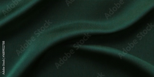 Smooth dark green satin fabric with gentle folds and soft lighting creating a luxurious and elegant texture