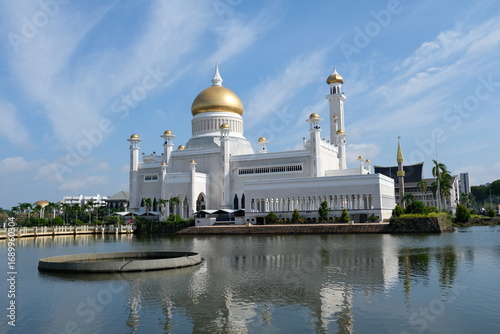 Iconic Omar Ali Saifuddien Mosque in Bandar Seri Begawan, Brunei, featuring a golden dome and minarets reflected in the surrounding lagoon.