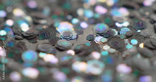 Colorful sequins scattered on a textured surface