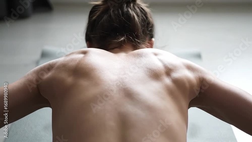 Strength training progression close-up focusing on muscular back development and toning physique