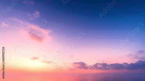 Serene ocean view at sunset with colorful sky featuring pink, orange, and purple clouds above calm water