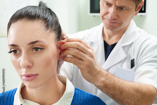 Wallpaper Mural Plastic surgeon examines ear of patient before plastic surgery Torontodigital.ca