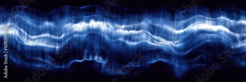 Abstract flowing blue light waves creating a sense of motion and energy against a dark background