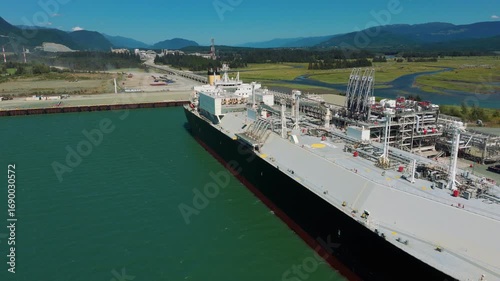 A liquified natural gas transport ship at dock waiting for loading
