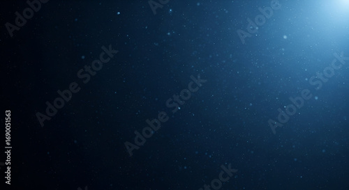 Enigmatic dust particles float softly in a dimly lit, deep blue void ambiance
