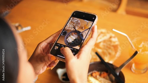 Young Woman in Japanese Cafe Taking Photo of Vegan Ramen with Tofu using Smartphone
