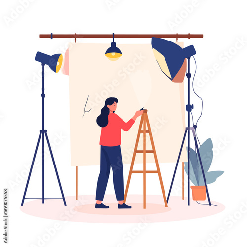 Female artist working on a large canvas in a creative studio.