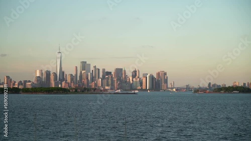 Wallpaper Mural The New York City skyline offers a breathtaking view with the One World Trade Center and the Hudson River seen under a partly cloudy sky, showcasing the beauty of this iconic city Torontodigital.ca
